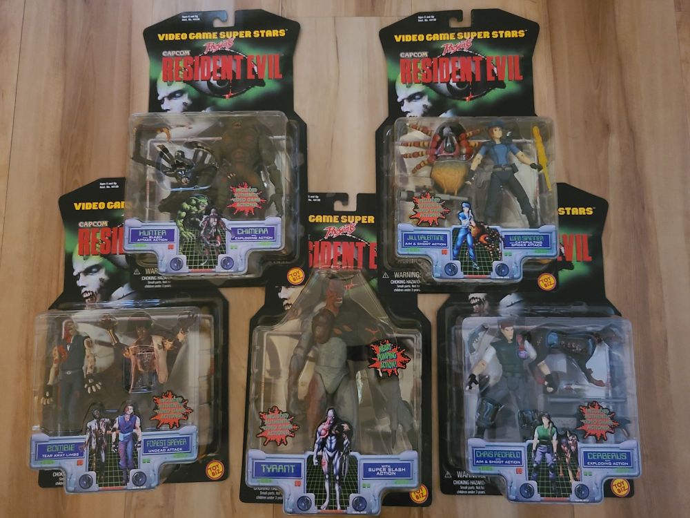 Carded ToyBiz Resident Evil toy. Top row, left to right Chimera and Hunter, Jill and Webspinner. Bottom row l to r, Zombie and Forest Speyer (also a zombie), Tyrant, Chris and Cerberus.