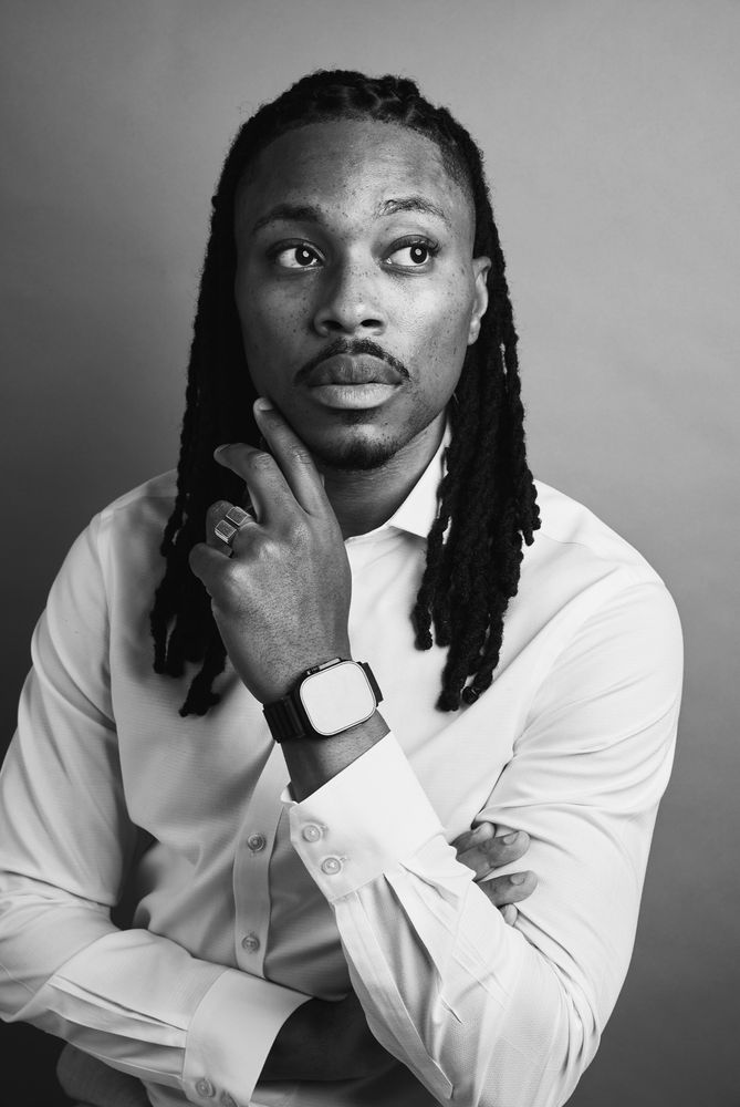 Black and white photo of a man in a white shirt. 