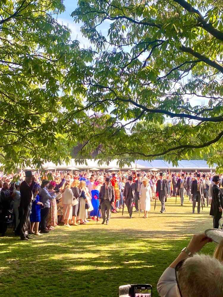 The Royals with top hats making their way into the garden party.  