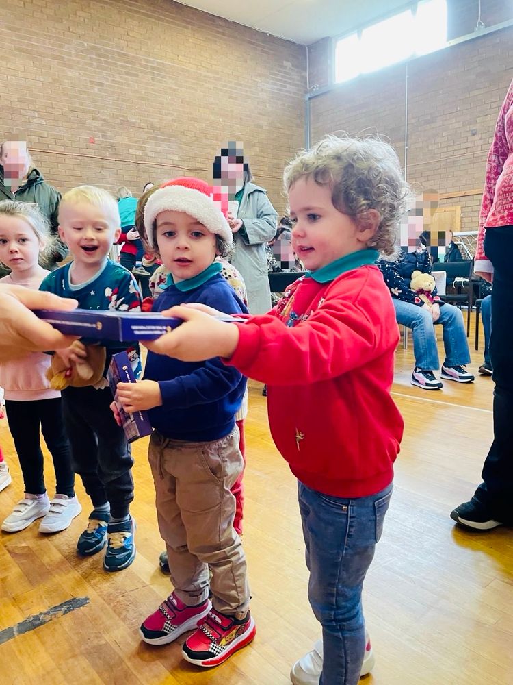 Christmas party at Naíscoil na Seolta. Some of the paistí receiving their presents!