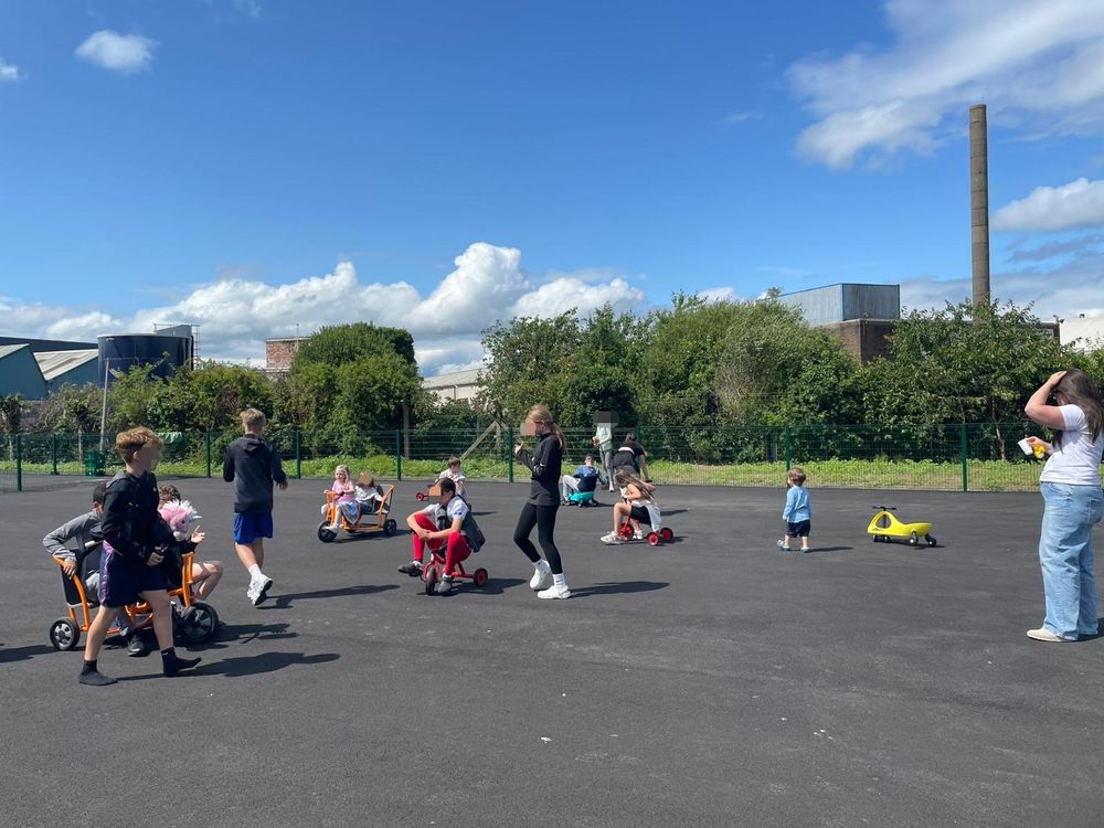 Fun day at Scoil na Seolta, out the back with little ones and big ones on scooters in the playground. 