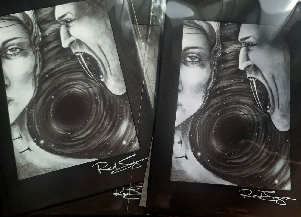 Mat-framed art. Black & white, ink & charcoal. Two people. One woman, one vampire man. Swirling vortex of stars behind.