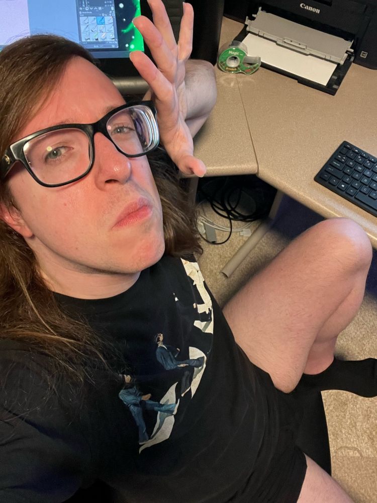 Me. White, nonbinary, long dirty blonde hair, glasses.

I'm in my studio, top-down perspective. Black Beatles Abbey Road T-shirt, black underwear, nothing else.