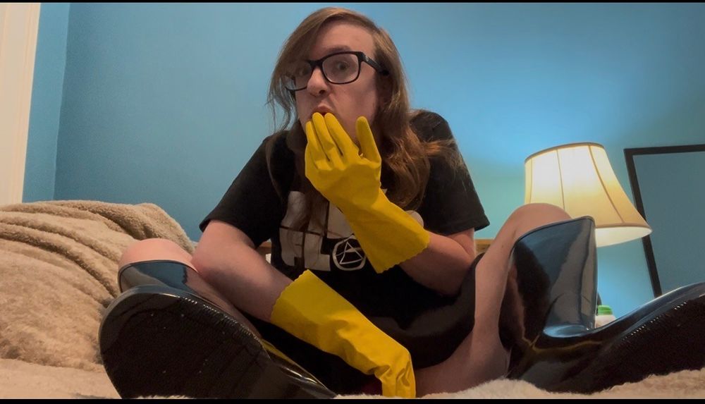 Me. White, nonbinary, long dirty blonde hair, glasses. On my bed.

I'm wearing a black Pink Floyd shirt, a black skater skirt, black glossy rubber boots, and yellow household gloves. On hand on my mouth, giving an gasping look, the other covering my more exposed crotch area lol.