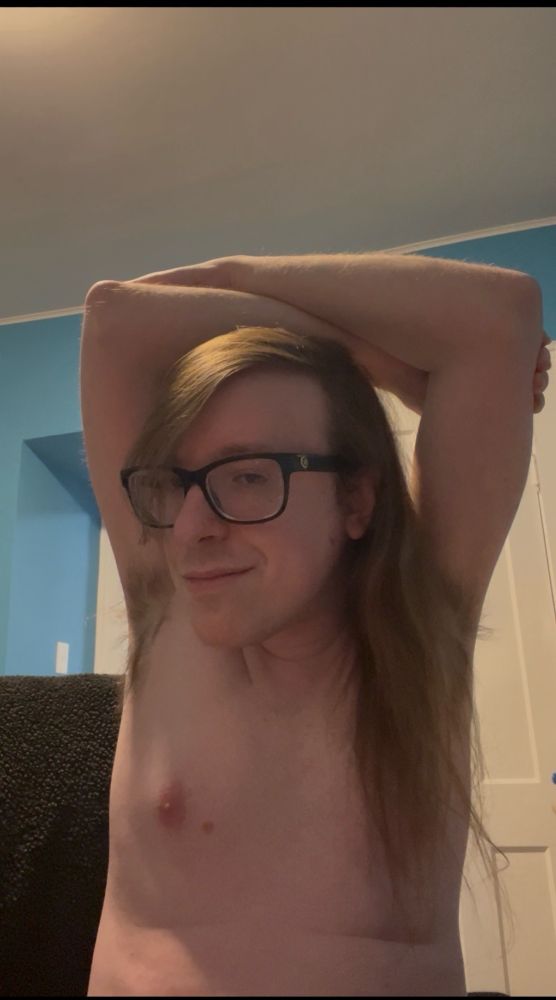 Me without a shirt on, lol. Hairy armpits and enby-tits in view.