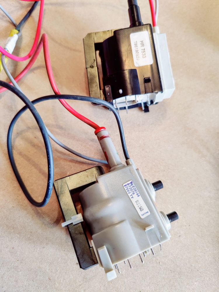 Old monitor faulty line output transformer (bottom) with strange bulge, compared to new line output transformer (top).