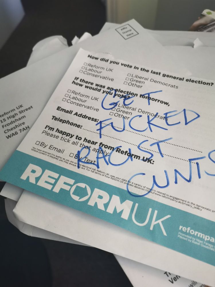 A reform questionnaire with get fucked racist cunts written on it and a reply envelope with no stamp. 