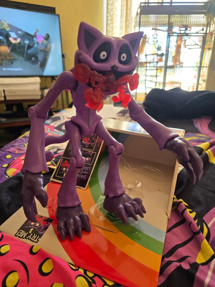These are a series of images showing off the details of the monster catnap 12" deluxe figure. Showing it pose and light up