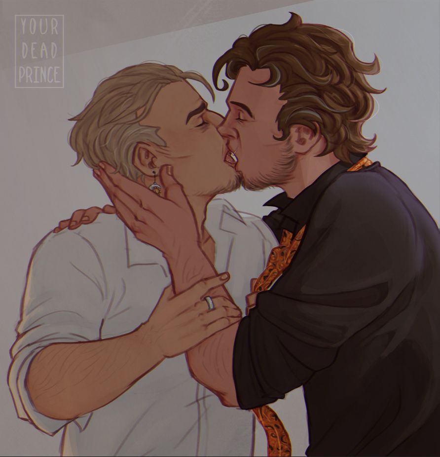 Arkadiusz and Karol kissing. Karol is gripping Arek's orange tie, tugging him closer, as his other hand rests on the man's arm. Arkadiusz is gently holding Karol's face with his left hand, the other resting on the man's shoulder. Both of them have their eyes closed.