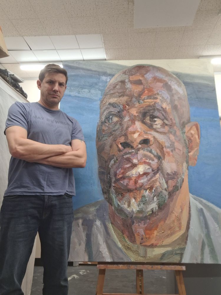 'Cliff, outreach worker', oil on canvas, 60inches x 48inches. 

I painted Cliff a few years ago as part of a project of portraits of people living and working in the London borough of Haringey. I have just finished this large scale portrait of him as part of a series of paintings of people with facial difference. Cliff's jaw was broken when he was a child, it was never properly re-set.

I would like to thank Cliff for giving me his time and for letting me include him in this project. The second photo shows me next to the painting for scale.
