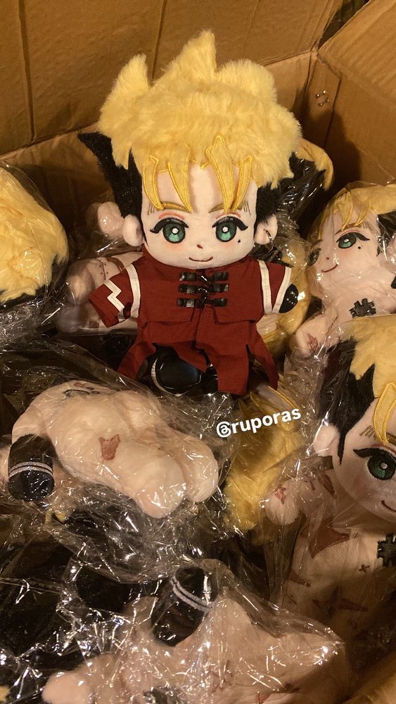 picture taken of a fanmade vash doll clothed sitting amongst a pile of unclothed vashies.