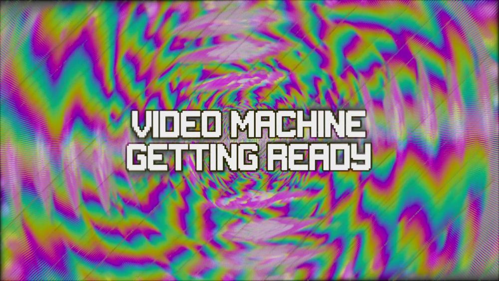 A colorful image of a feedback loop effect. The text in the middle of the screen reads "Video Machine Getting Ready"