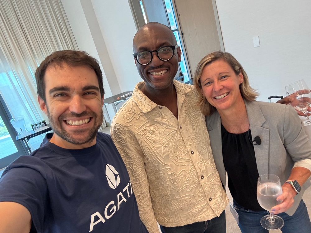 three people smiling while taking a selfie