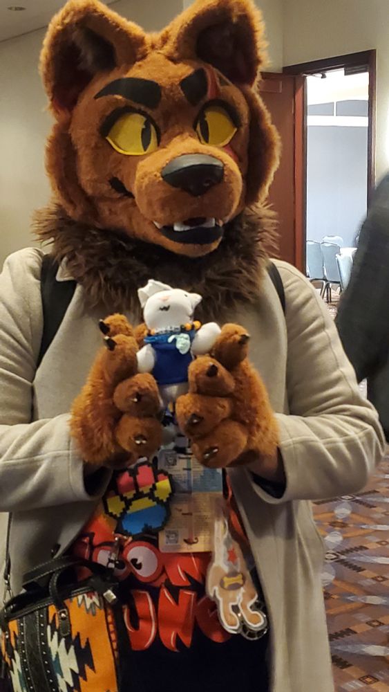 Red Bonez holding up a little tiger