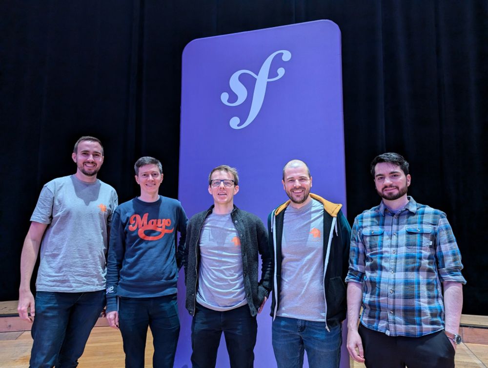 Team photo in front of Symfony Logo