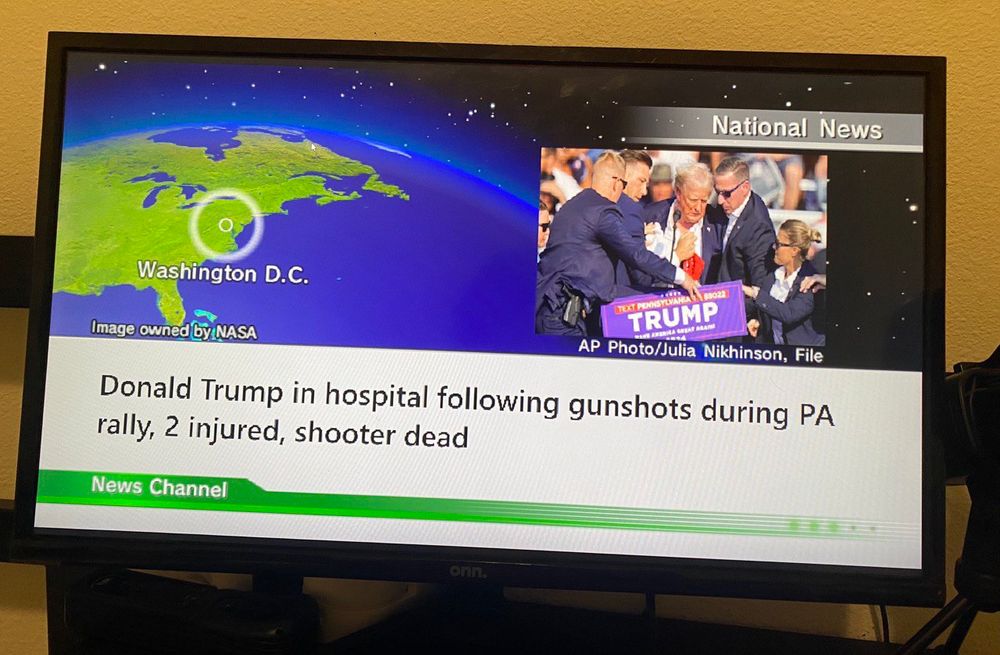 A Wii News Channel update that says “Donald Trump in hospital following gunshots during PA rally, 2 injured, shooter dead”
Above the text is a map highlighting Washington DC and a photo showing Donald Trump being herded by Secret Service agents