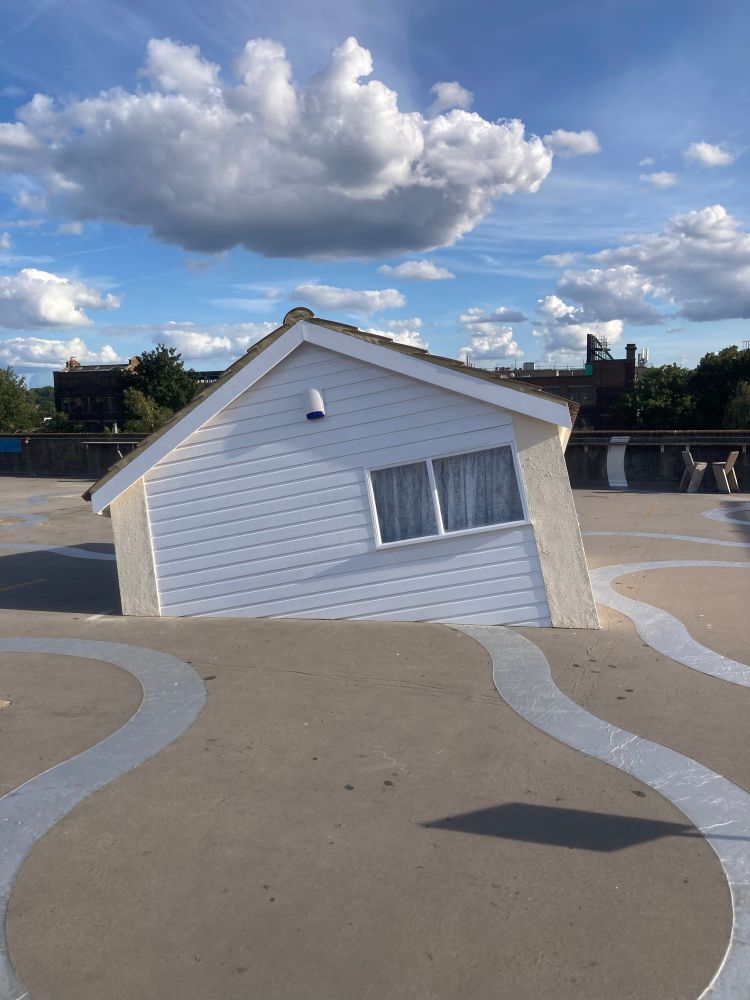 Fluffy cloud above Raheel Khan’s Best Wishes, a house half sinking into Bold Tendencies’ concrete floor