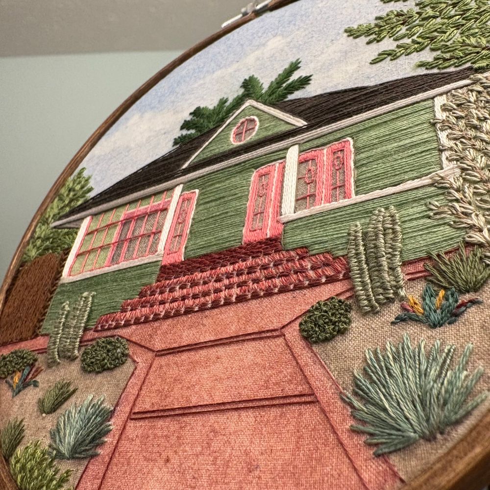 A close up of the garden. 3D cactus made with a detached woven picot stitch, French knot bushes, a colorful succulent(?), and other plants to create a lovely desert garden. 