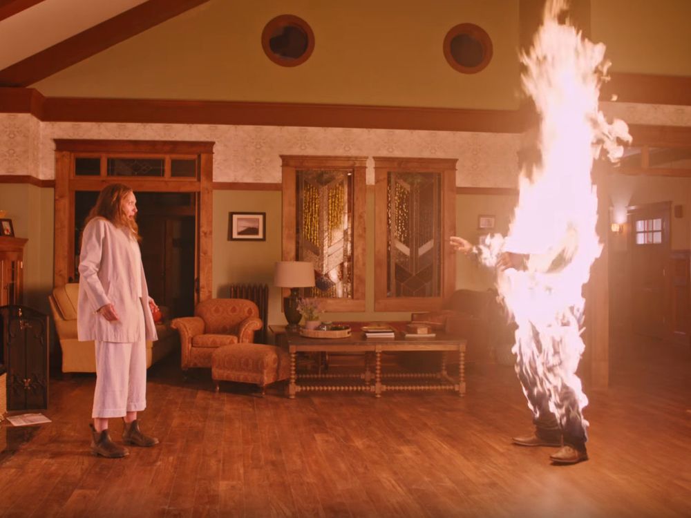 An image from the movie Hereditary, featuring Toni Collette starring at an immolating [REDACTED ACTOR NAME TO PREVENT SPOILERS].