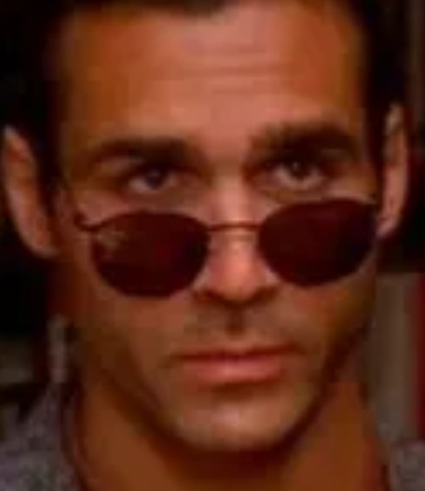 image is of Dunkin Donuts, a man whose killer instinct no sunglasses can hide. here he is looking dumb because he always looks dumb.