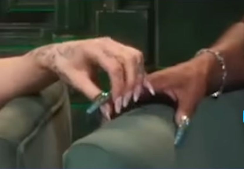 ariana grande using her fingertips to gently grasp cynthia erivo’s index finger…yep you heard that right, it’s as weird as it sounds