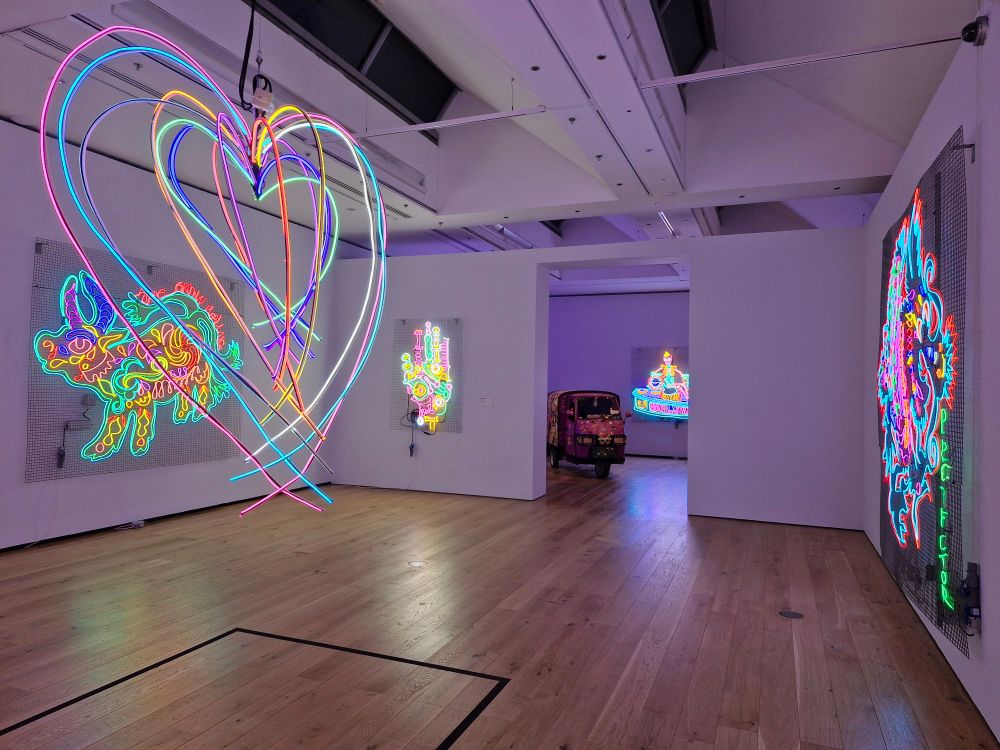 Chila Kumari Singh Burman exhibition at Compyon Verney, photo shows several pieces of art made from neon lighting.