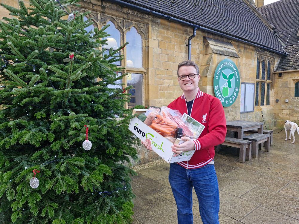 Image shows me outside Ilmington Shop holding a box full of locally produced food.