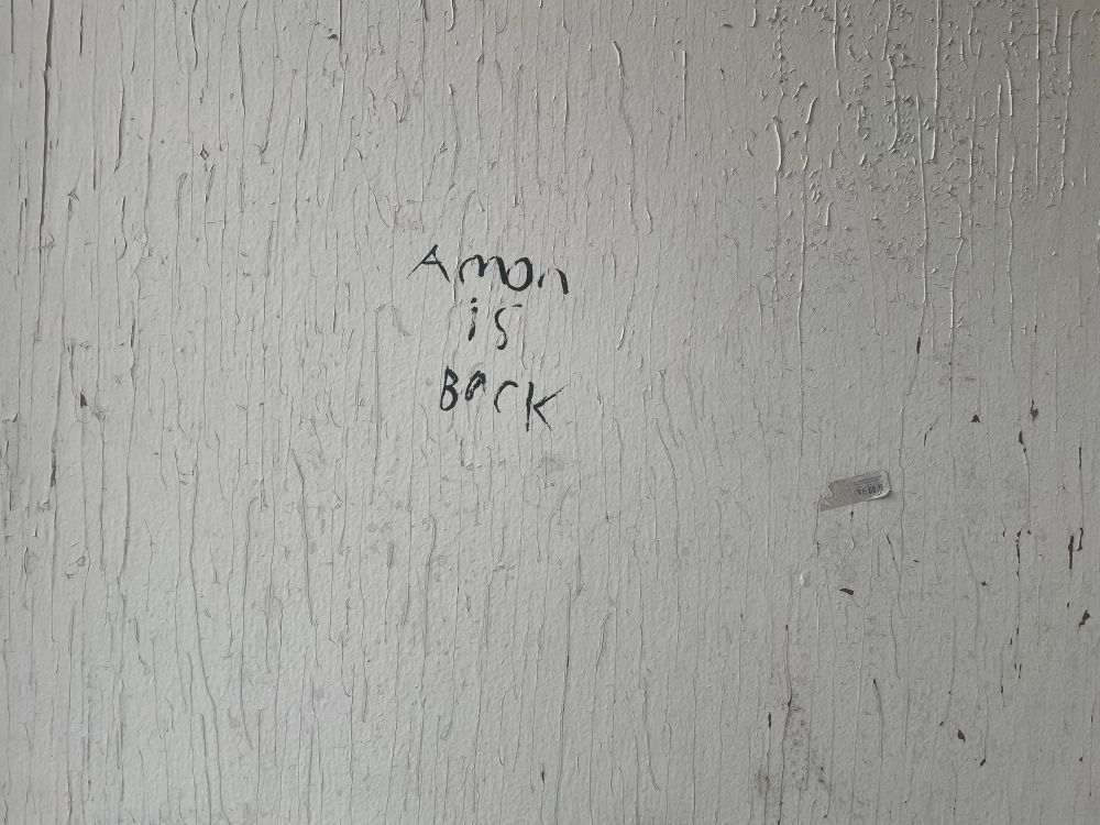 graffiti that reads “Amon is back.”