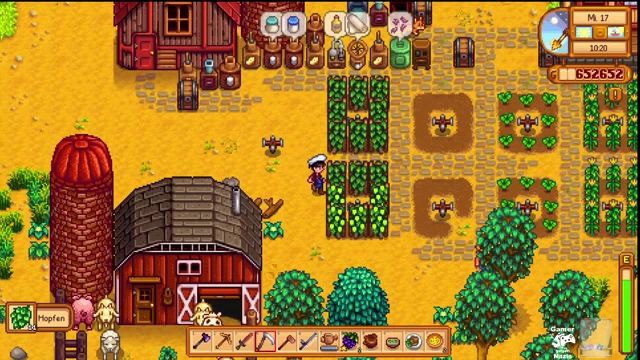 a screenshot of a video game called stardew valley showing a red barn