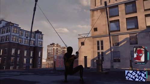 a man in a spiderman costume is swinging from a rope