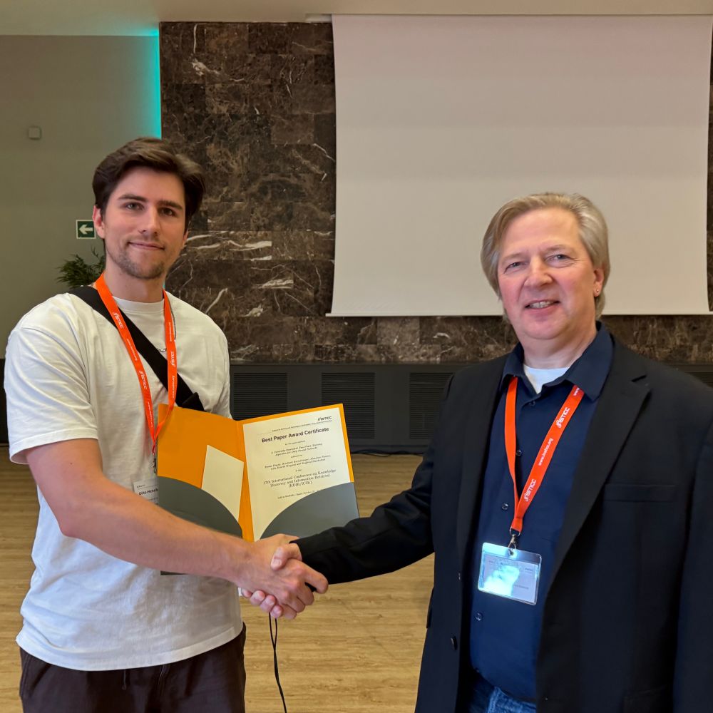 Handshake and handover of the Award by Prof. Lars Nolle