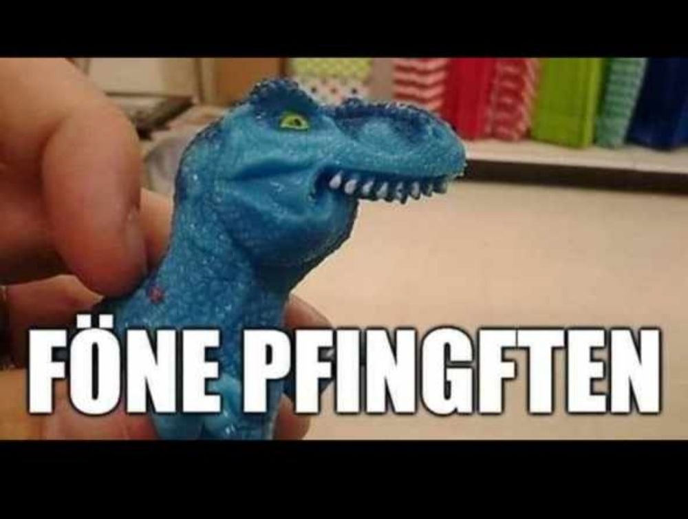 Ein Dinosaurier Handpuppe mit starken Überbiss wünscht "föne Pfingften "