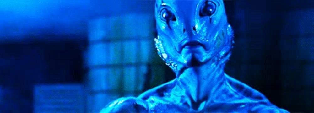 a close up of a blue alien with a blue background