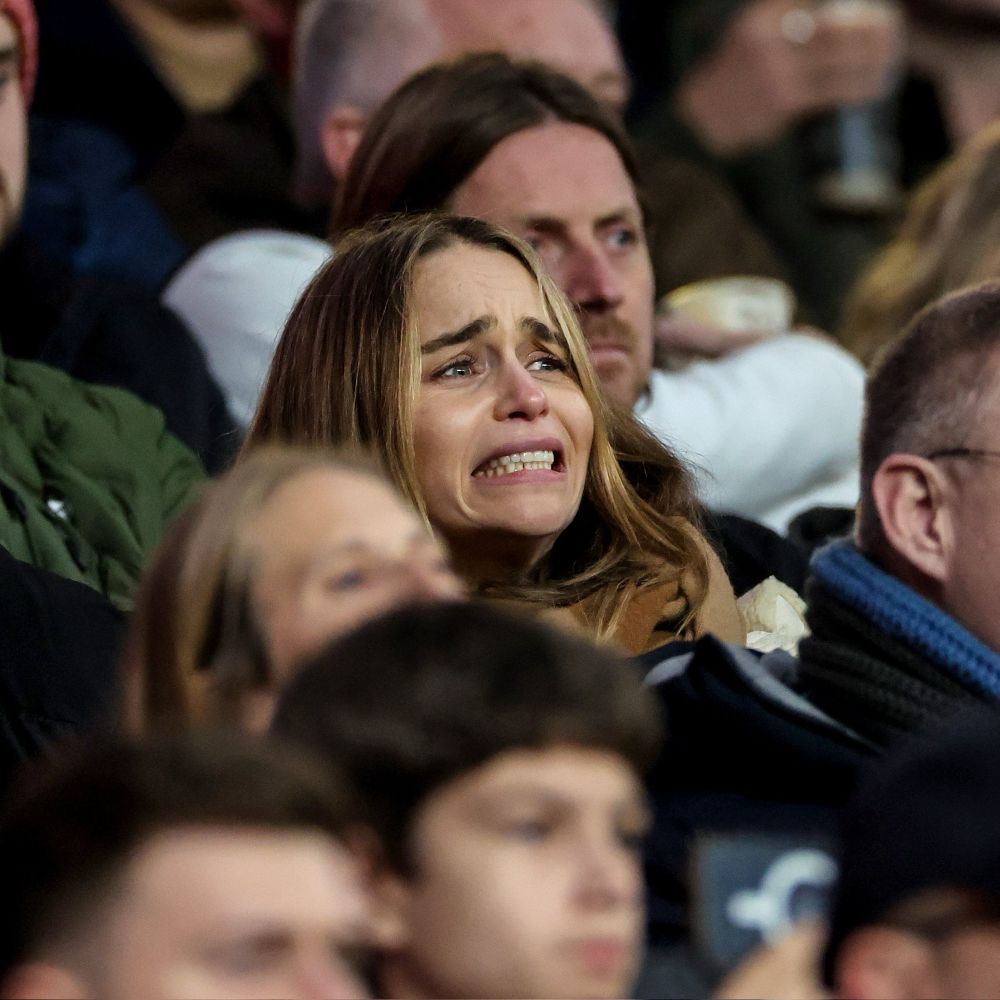 Emilia Clarke at a game, with a stressed look on her face. 😬