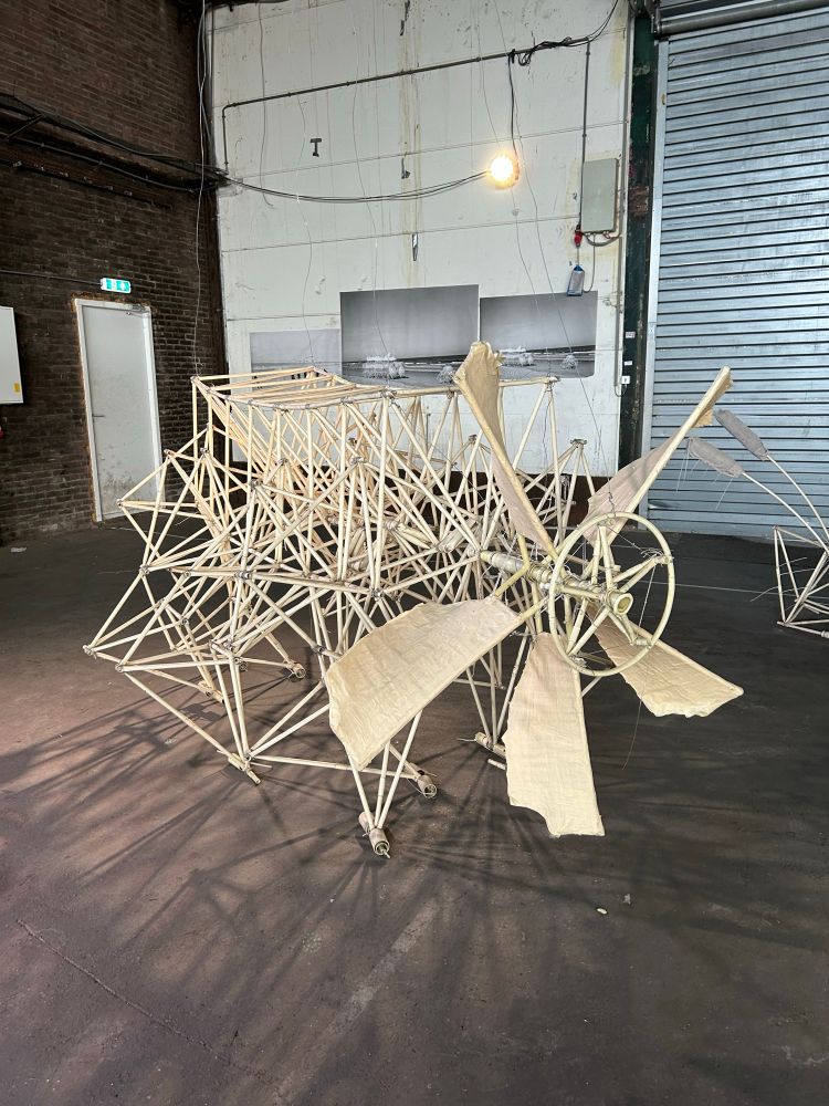 A strandbeest with a set of wind blades on the front 