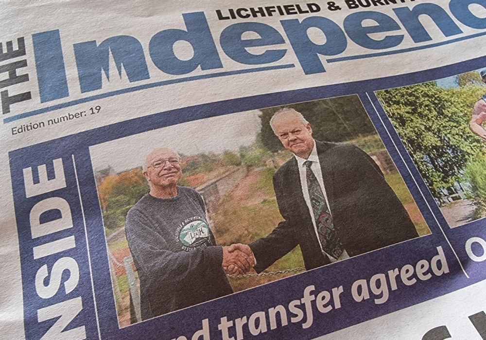 A photo of the Lichfield and Burntwood Independent with the text: Inside - Land transfer completed and two men  shaking hands.