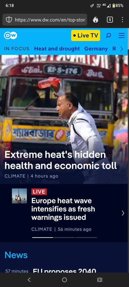 Photo of man on front of a Kolkata minibus pouring water on his head to cool down