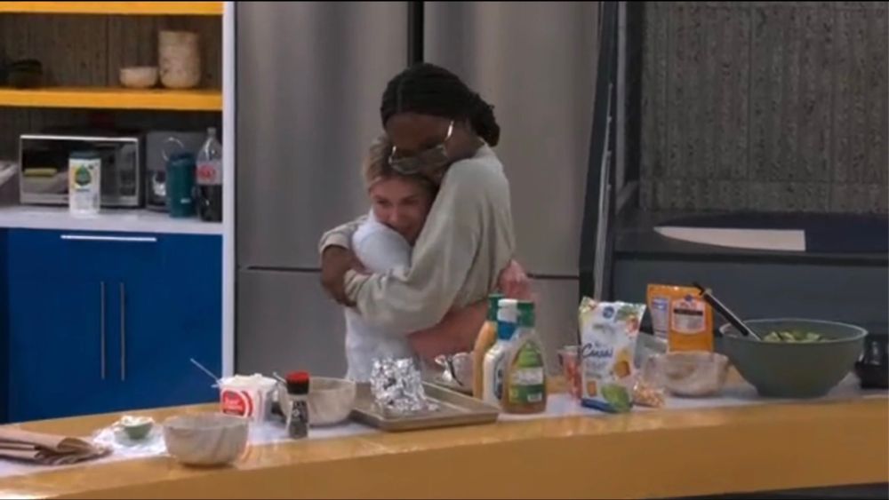 Leah and tkor from bb26 hugging in the kitchen