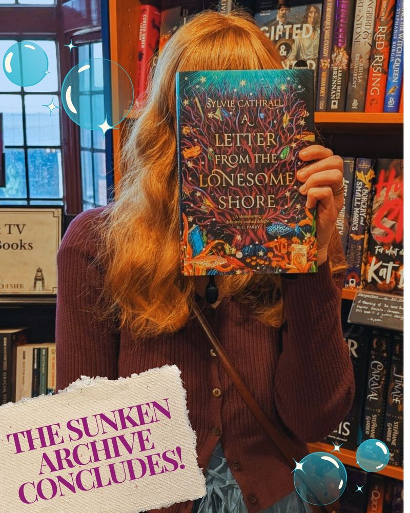 Sylvie, a white woman with strawberry-blonde hair, stands in a bookstore holding up a copy of A Letter from The Lonesome Shore (which, conveniently, blocks out her face). She's wearing a purple cardigan and teal dress to match the ocean and coral on her book cover. Text on an antique-style label reads "THE SUNKEN ARCHIVE CONCLUDES!" and sparkles and bubbles appear unnecessarily throughout.