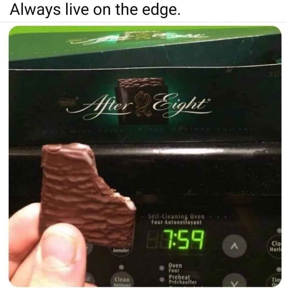 Twitter screenshot with the caption, "Always live on the edge."

the picture shows someone holding an After Eight chocolate with a bite taken out of it in front of a clock that reads 7:59