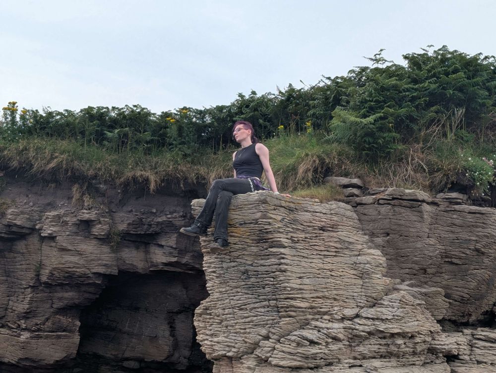 Luci completely zoned out sat on yet more cool rocks. She looks kinda like she's trying not to think about how many bones she'd break if she fell...