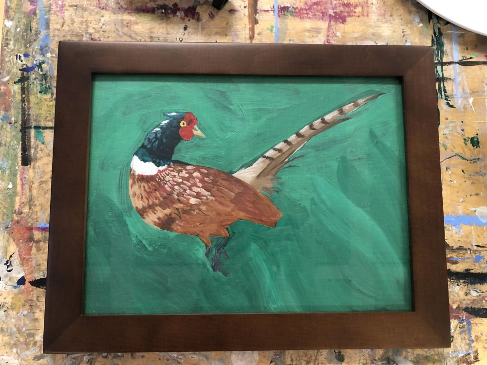 a framed acrylic painting of a pheasant, the grass stylized in waves.