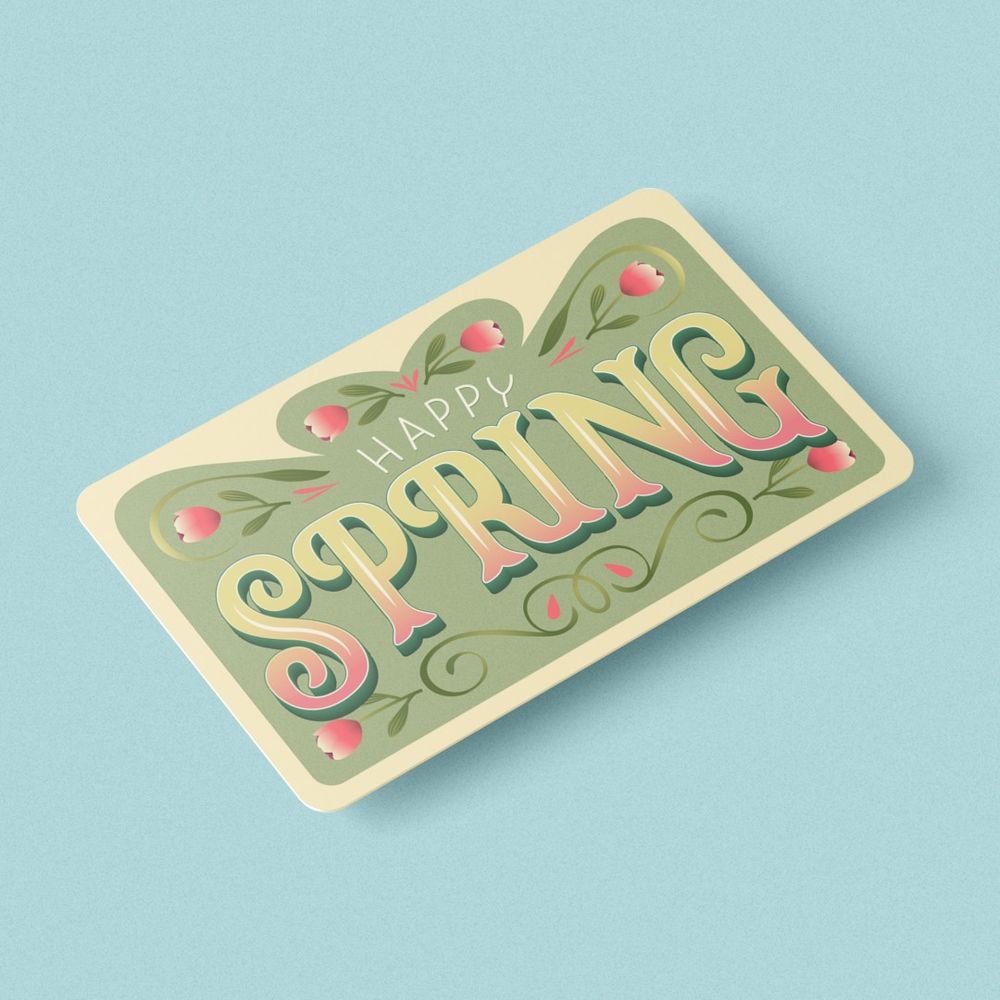 An image of an angled view gift card mockup of a lettering piece that says "Happy Spring" surrounded by flower illustrations on a green background.