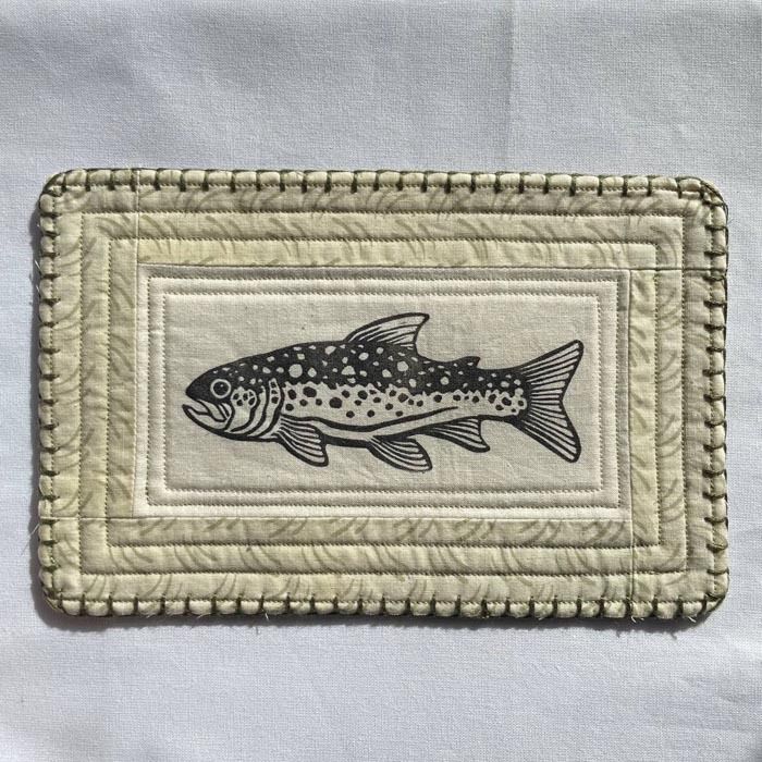 block printed trout patch with an off white and green patterned quilted background