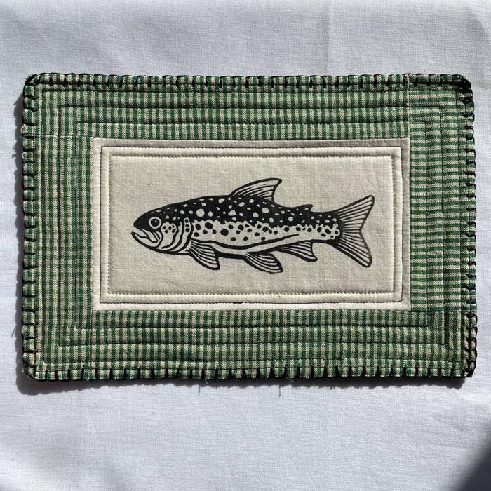 block printed trout patch with a dark green checked quilted background