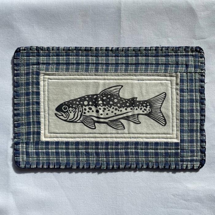 block printed trout patch with a blue plaid quilted background