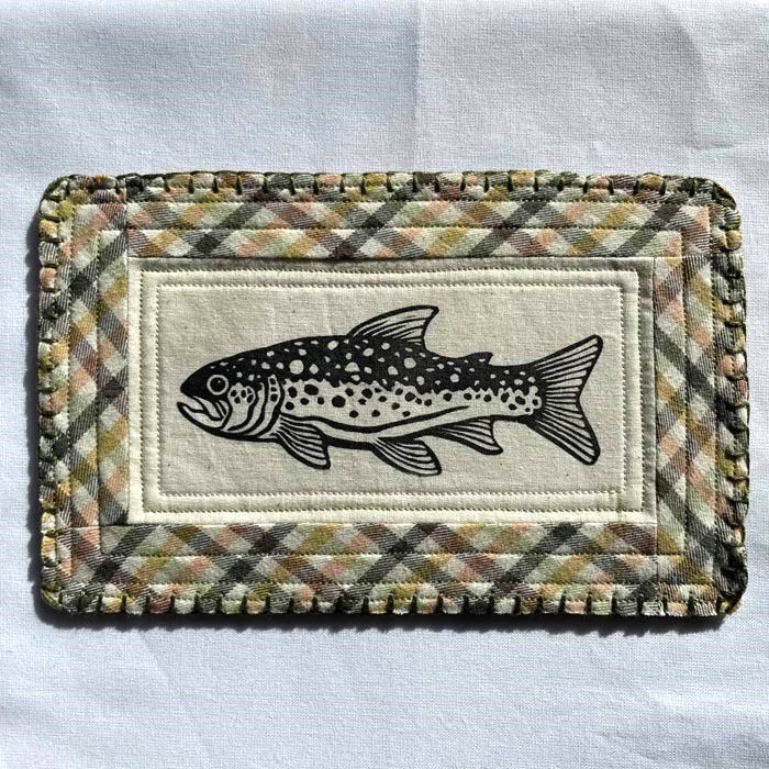 block printed trout patch with a green, yellow, and pink plaid quilted background