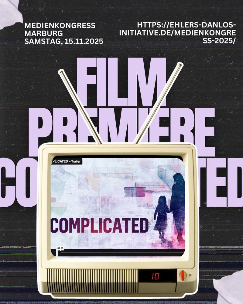 A poster announcing the German film premiere of COMPLICATED. At the center, an old retro TV with antennas shows the word “COMPLICATED” on screen, next to silhouettes of an adult and a child holding hands. Above it, large lavender letters read “FILM PREMIERE COMPLICATED.” The text at the top says “Medienkongress Marburg, Saturday, Nov 15, 2025” and the URL “https://ehlers-danlos-initiative.de/medienkongress-2025/”. The design has a nostalgic, VHS glitch aesthetic.
