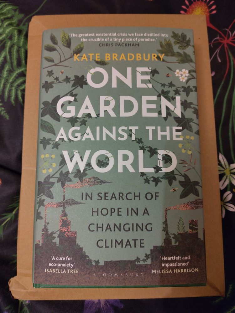 A photograph of a hardback book by Kate Bradbury called One Garden Against the World.