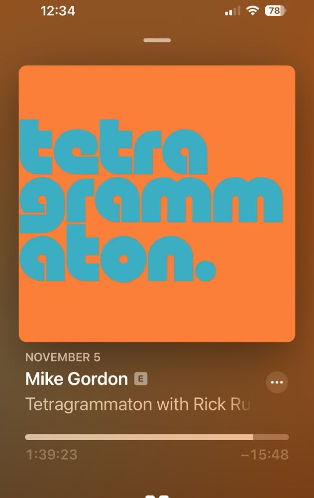 Screenshot of Tetragrammation Podcast with Rick Rubin with Teal lettering and orange background for the Mike Gordon episode showing 1:39 as the time stamp